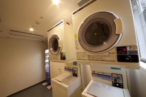 a washing machine and a washer and dryer in a room at Hotel Hokke Club Kagoshima in Kagoshima