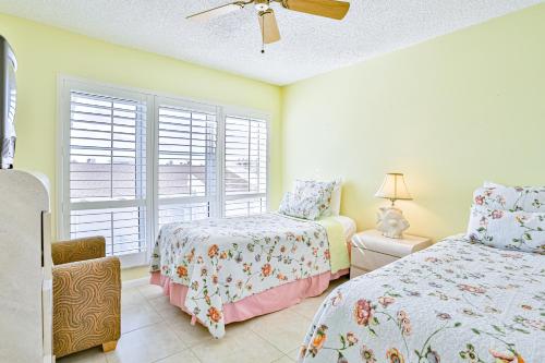 a bedroom with two beds and a window at Madeira Beach Yacht Club 343 #G in St. Pete Beach