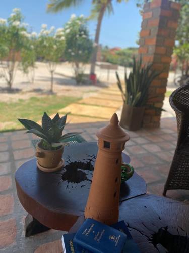 a toy lighthouse sitting on top of a table at Pousada Sitio Parque dos Lençóis in Barreirinhas