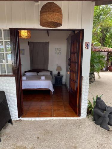 a bedroom with a bed and a door leading into a room at Macao Beach in Sámara