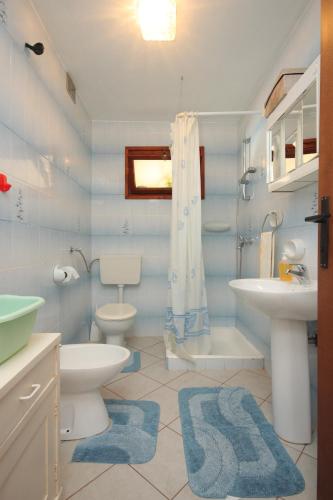 a bathroom with two toilets and a sink and a shower at Apartments by the sea Nerezine, Losinj - 3479 in Nerezine