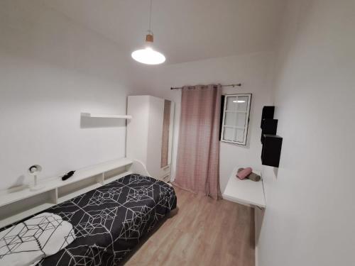 a hotel room with a bed and a sink at Friendly house in Funchal