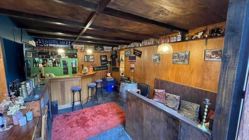 a pub with a bar with a counter and chairs at Enchanted Escape in Picton