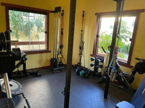 a gym with a bunch of exercise equipment and windows at Casa Fogo in Itaúnas