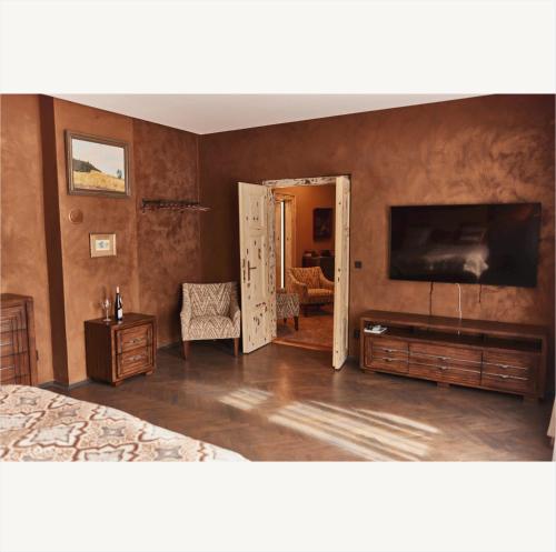 a bedroom with a bed and a flat screen tv at Apartmány Pekárna 1898 in Beroun