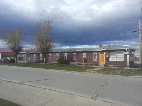 a small house on the side of a street at Hostal Don Pedro in Puerto Natales