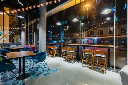 a bar with chairs and tables in a restaurant at Tru by Hilton Hanoi Station in Hanoi