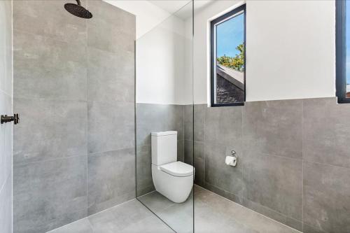 a bathroom with a toilet and a window at Terminus Hotel Pyrmont in Sydney