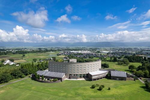 an overhead view of a building on a green field at KAMENOI HOTEL Aso in Aso