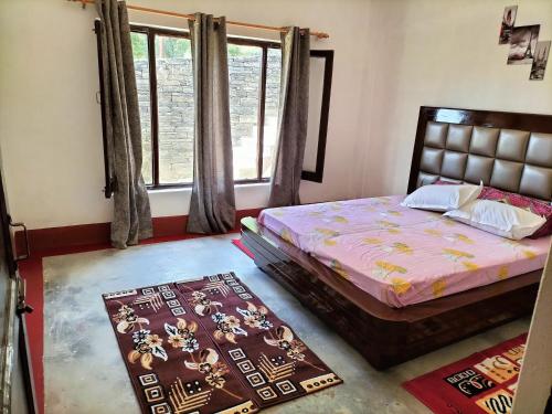 a bedroom with a bed and a window at Le Jardin . (The garden) in Almora