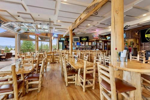 an empty restaurant with wooden tables and chairs at Gateway Inn in Grand Lake