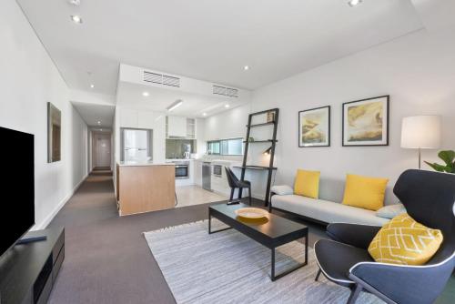a living room with a couch and a table at Quattro on Astor in Brisbane