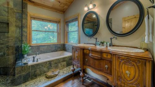 a bathroom with a tub and a sink and a mirror at Stairway to Heaven in Morganton