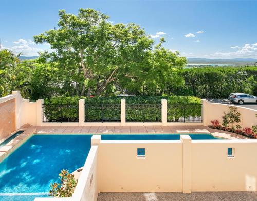 a swimming pool in the backyard of a house at Belle De Jour, Penthouse 5, Noosa Heads in Noosa Heads