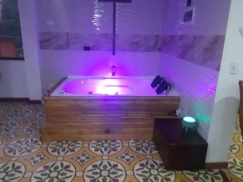 a bath tub with purple lights in a room at Hospedaje Rural El Rancho de Amelia y Juancho in Silvania