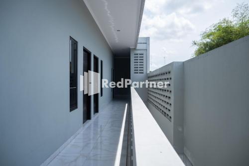 a view of the facade of a red partner building at Athena House Syariah Near The Park Mall Solo Baru Mitra RedDoorz in Sukoharjo