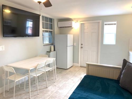 a kitchen with a table and a white refrigerator at Private Hollywood APT Near Beach Airport & Casino in Hollywood