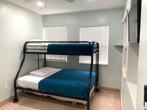 a bedroom with two bunk beds and a window at Private Hollywood APT Near Beach Airport & Casino in Hollywood