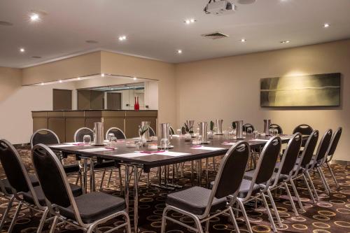 a conference room with a long table and chairs at Crowne Plaza Canberra by IHG in Canberra