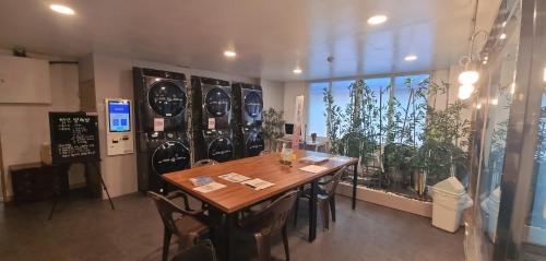 a table and chairs in a room with plants at Raemian in Chungju