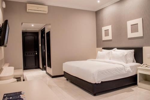 Luminor Hotel Jember By WHにあるベッド