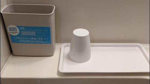 a styrofoam container sitting next to a trash can at Toyoko Inn Tokyo Otsuka-eki Kita-guchi No 1 in Tokyo