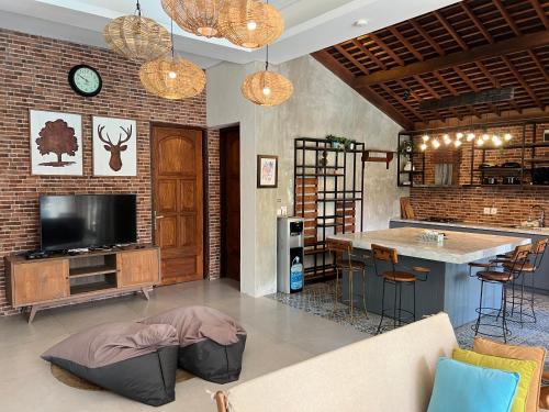 a living room with a couch and a bar at Casa Ola Villa Pererenan in Canggu