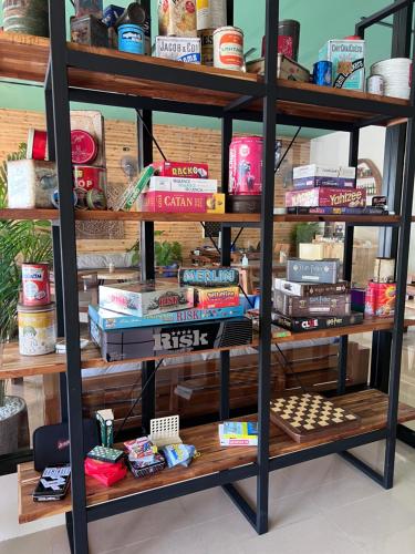 a book shelf filled with books and other items at Pearl of Samui Resort in Lamai