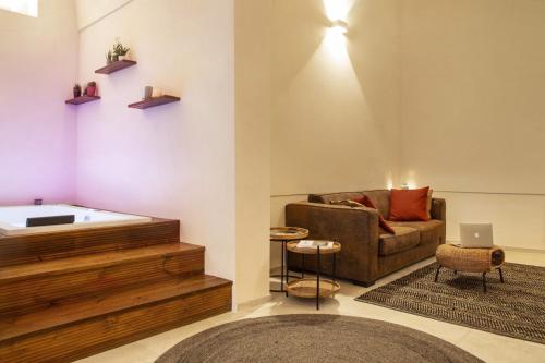 a living room with a tub and a couch at ELLEMENTS - Luxury Rooms in Brindisi