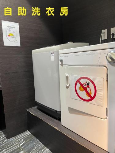 a white oven with a no smoking sign on it at V-one Vogue Hotel in Taipei