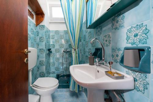 a bathroom with a sink and a toilet at Kouvlaki Effie's Place in Afissos in Afissos