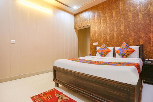 a bedroom with a large bed in a room at FabHotel Limewood in Dehradun