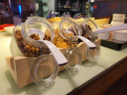 a bunch of jars of food sitting on a table at Ibis Kaunas Centre in Kaunas