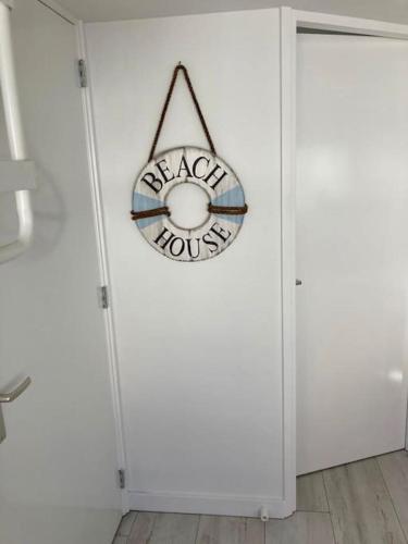 a white door with a anarchy sign on it at Have a nice stay! - Beachhouse Stranddistel 100m from the beach in Noordwijk aan Zee