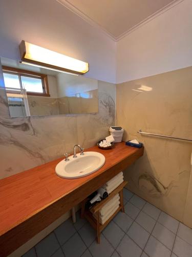 a bathroom with a sink and a mirror at Sturt Motel Balranald in Balranald