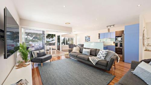 a living room with a couch and a table at Dutchmans Bay Escape 45A Thurlow in Nelson Bay