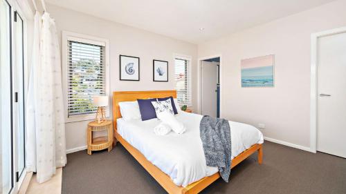 a bedroom with a large bed and a window at Dutchmans Bay Escape 45A Thurlow in Nelson Bay