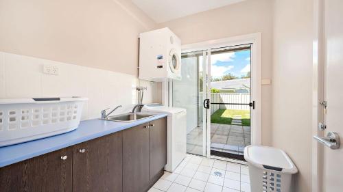 a kitchen with a sink and a counter top at Dutchmans Bay Escape 45A Thurlow in Nelson Bay