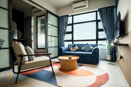a living room with a couch and a table at Jesselton Quay by Pinstay in Kota Kinabalu