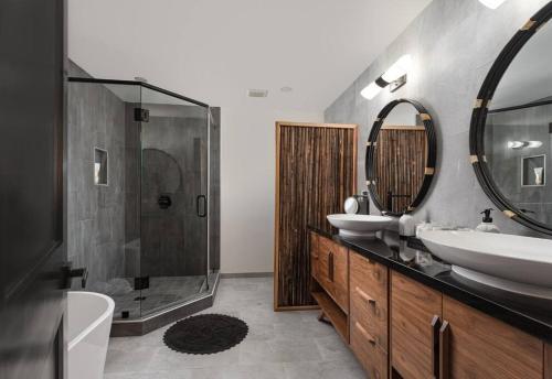 a bathroom with two sinks and a shower at Tropical Beach Villa with Deck, Spa Walk to Ocean in Santa Barbara