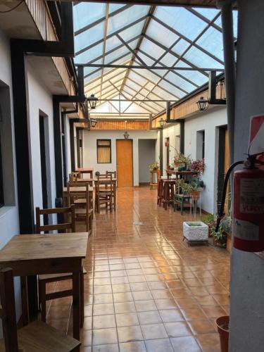 a room with tables and chairs and a glass ceiling at Cirse in Río Gallegos