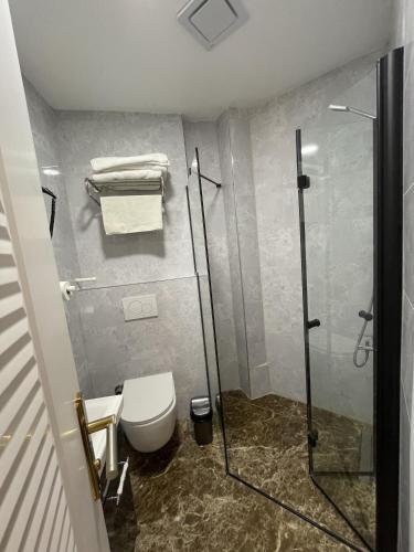 a bathroom with a toilet and a glass shower at Turna HOTEL in Istanbul