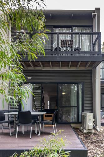 a house with a balcony with a table and chairs at Forestview Apartment Margaret River in Margaret River Town