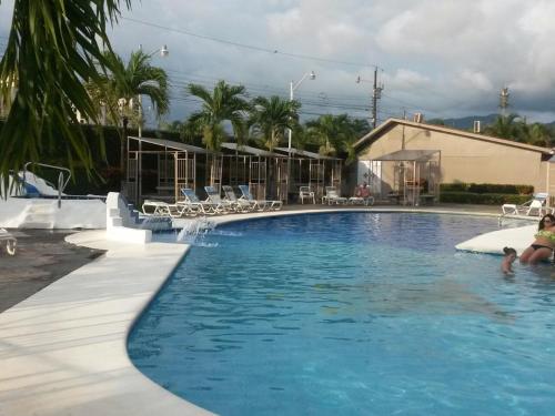 a woman and child in a swimming pool at Condominio Tropical villa 2 in Jacó