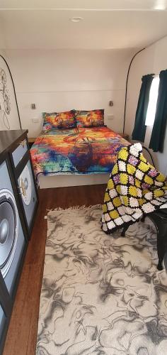 a bedroom with two beds and a rug at Rose City Caravan Park in Warwick