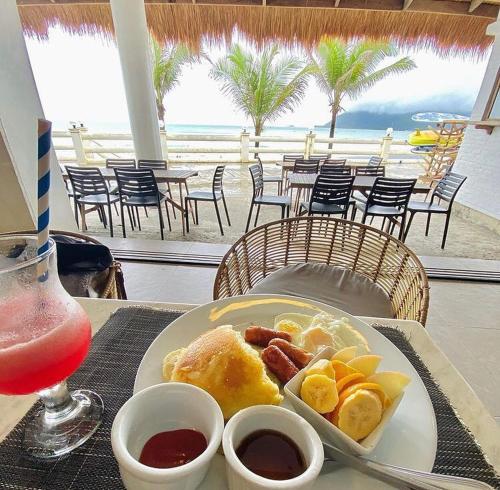 a plate of food on a table with a drink at Bay's Inn Resort in Baler