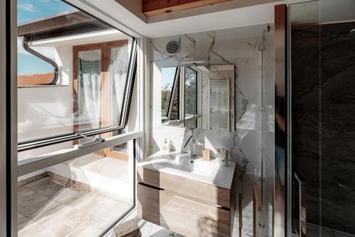 a bathroom with a sink and a mirror at La Casa di Gabri in Málchina