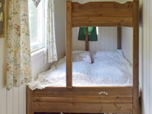 a wooden bunk bed in a room with a window at Holiday home Berg I Østfold in Dale