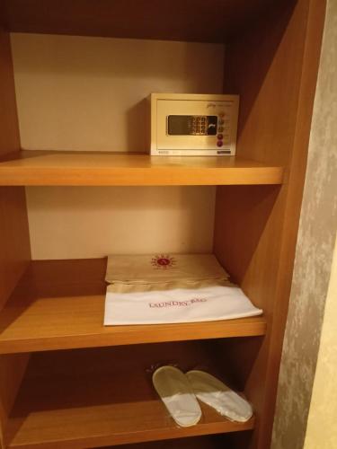 a microwave oven sitting on top of a shelf at Abhyagama Hotel in Digha