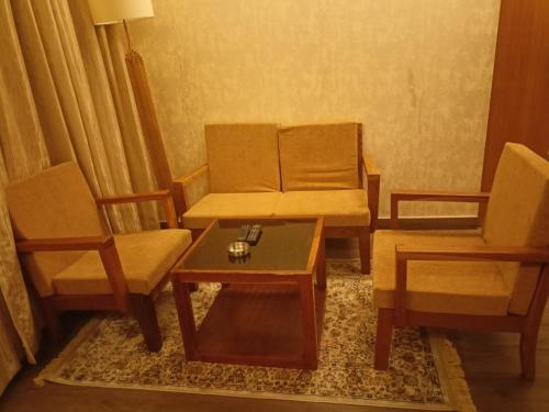 a living room with two chairs and a coffee table at Abhyagama Hotel in Digha